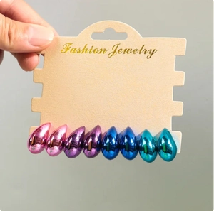 Detail of four pairs of teardrop earrings in polished pink, purple, blue, and green finishes