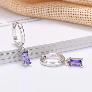 Macro shot of S925 sterling silver stamp and rectangular purple zircon stone on the earring