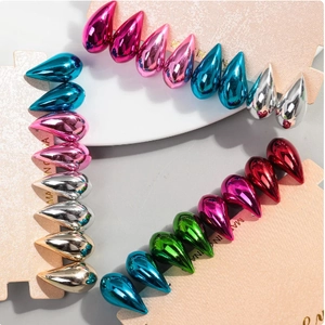 Polished teardrop earrings in multiple metallic colors displayed on cardholder