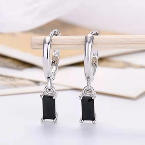 Detailed macro shot of S925 silver stamp on earring with rectangular black zircon drop