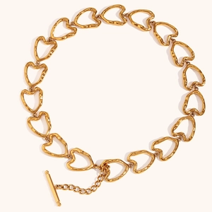 Handmade gold plated stainless steel heart link necklace with toggle clasp on white background