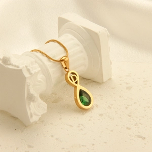 Golden necklace with letter D infinity pendant and green pear-cut gemstone on snake chain
