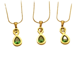 Gold infinity letter necklaces with green teardrop gems and sleek snake chains