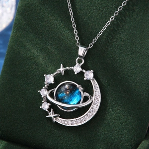 Macro shot of blue planet necklace with silver Saturn ring and zircon inlay details