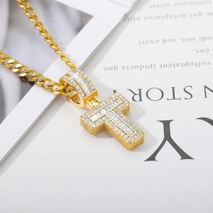 Macro shot of gold hip hop letter T pendant with micro-paved cubic zirconia stones