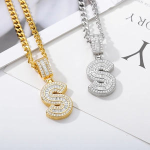 Detail of gold and silver letter S pendants with pave set cubic zirconia on Cuban chains