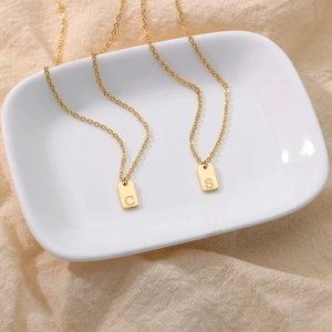 Gold stainless steel vertical rectangular pendant necklace with engraved letters C and S