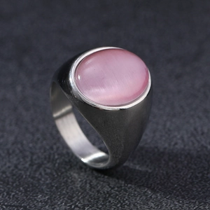 Macro detail of oval pink cat's eye stone set in a brushed silver stainless steel ring