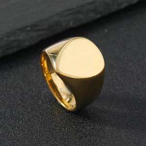 Macro shot of polished gold-plated stainless steel ring with a smooth triangular flat top