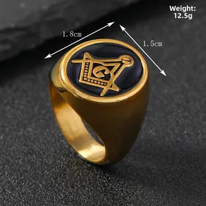 Detail of masculine Masonic ring with black enamel and gold compass logo on rock surface