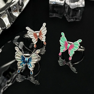 Detailed view of three colorful liquid butterfly rings with gradient enamel on silver band