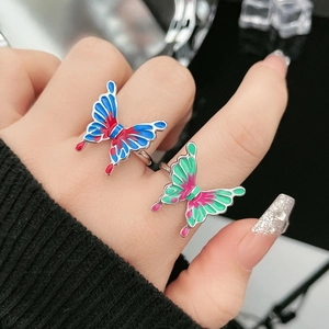 Detail of colorful butterfly open ring featuring enamel oil drip technique and silver band