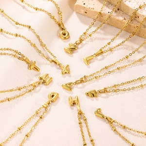 Detailed view of 18K gold plated 3D bubble initial pendants on elegant thin necklaces