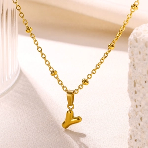 Detail of 18K gold-plated stainless steel ball chain with bubble letter Y pendant