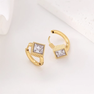 Macro detail of 18k gold earrings with square stones and fine vertical textures