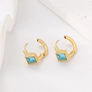 Macro view of 18k gold plated stainless steel earrings with square blue crystal stone