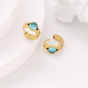 Detail view of gold vacuum plated 304 stainless steel earrings with blue crystal