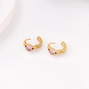 Detailed view of vacuum plated gold hoop earrings featuring pink gemstone accents
