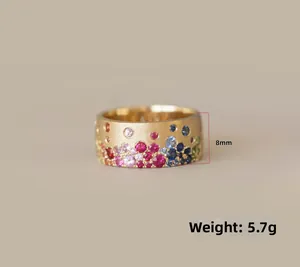 Detail showing 8mm wide gold band with multicolored gemstones and 5.7g weight info