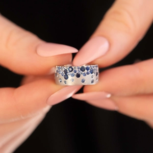Vintage French style silver ring with gradient blue zircons on model's hand