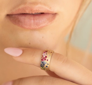 Detailed close-up of a matte gold vintage ring featuring a rainbow of multi-colored gemstones