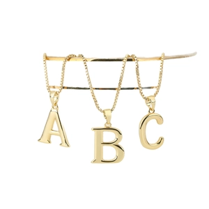 Golden A-Z initial letter necklaces set with elegant box chains on white display