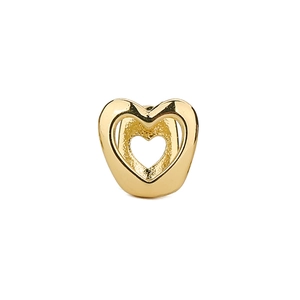 Detailaufnahme von goldenem, hohlem, herzförmigem Zahnschmuck mit polierter Oberfläche