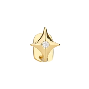 Makroaufnahme von goldenen Stern-Zahnschmuck mit einem mittig funkelnden runden Zirkonstein