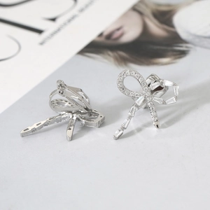 Silver bow ribbon clip-on earrings with shimmering pavé zircon stones for non-pierced ears
