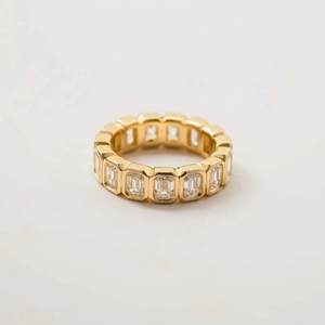 Macro shot of gold emerald-cut baguette cubic zirconia channel-set eternity ring band