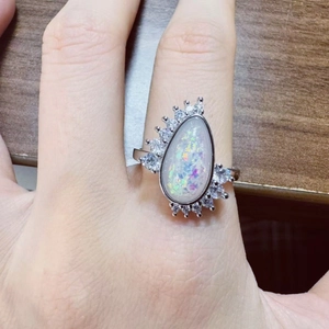 Vintage pear cut opal ring with sparkling crown diamond halo and silver finish
