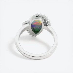 Elegant silver pear-cut opal ring with halo diamond setting on a clean white backdrop