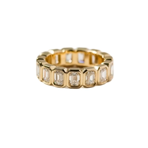 Elegant gold emerald cut eternity band ring with channel set cubic zirconia stones
