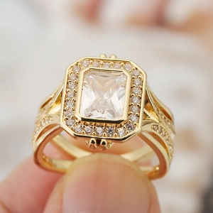 Macro shot of gold vintage ring featuring a large rectangular cut zircon and pavé diamonds