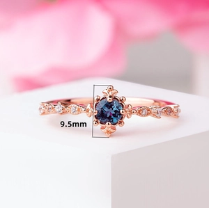 Macro shot of 9.5mm blue topaz gemstone ring with rose gold plating and diamonds