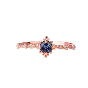 Elegant rose gold vintage ring with round blue topaz stone and diamond accents