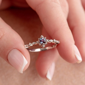 Elegant blue topaz silver ring with twisted band and sparkling side stones for women