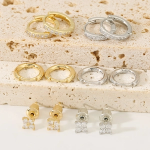 Sparkling four-leaf clover flower earring set with gold and silver huggie hoops