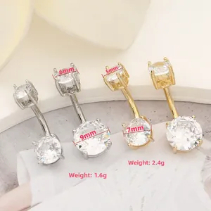 Detail view of double-ended round zircon belly rings in gold and silver finishes