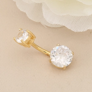 Golden belly button ring with sparkling double cubic zirconia in a curved bar design