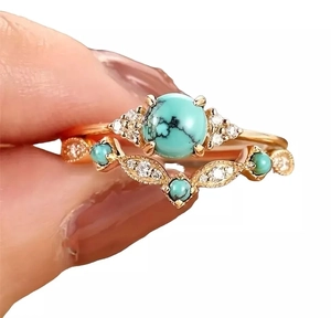 Detail shot of vintage Bohemian gold ring set with turquoise and crystal accents