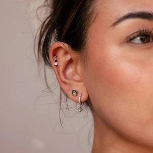 Macro shot of French vintage sea grass stone earrings with green agate and zircon