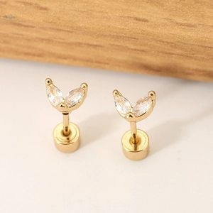 Close-up of golden butterfly stud earrings with marquise-cut marquise-cut zircons