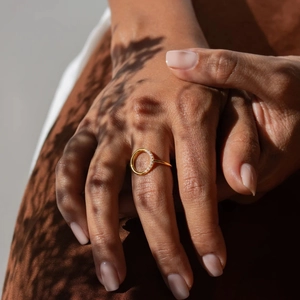Detailed close-up of 18K gold-plated geometric ring with half-circle pavé crystals