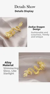 Detail of dragon brooch with golden alloy and white cubic zirconia on silk cloth