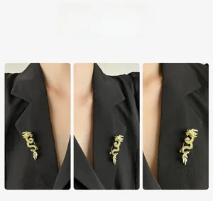 Detailed macro view of the gold-plated dragon brooch with sparkling rhinestones