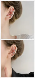 Macro detail of silver dragon ear bone clip with micro-set white zircon stones