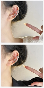 Detail view of silver dragon ear cuff with intricate sparkling rhinestone inlay