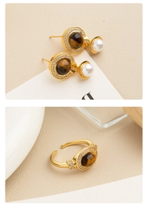Detail view of tiger eye stone jewelry set with gold finish, pearls, and crystals