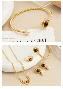 Detailed set of gold-plated tiger eye jewelry with pearls, ring and twisted bangle